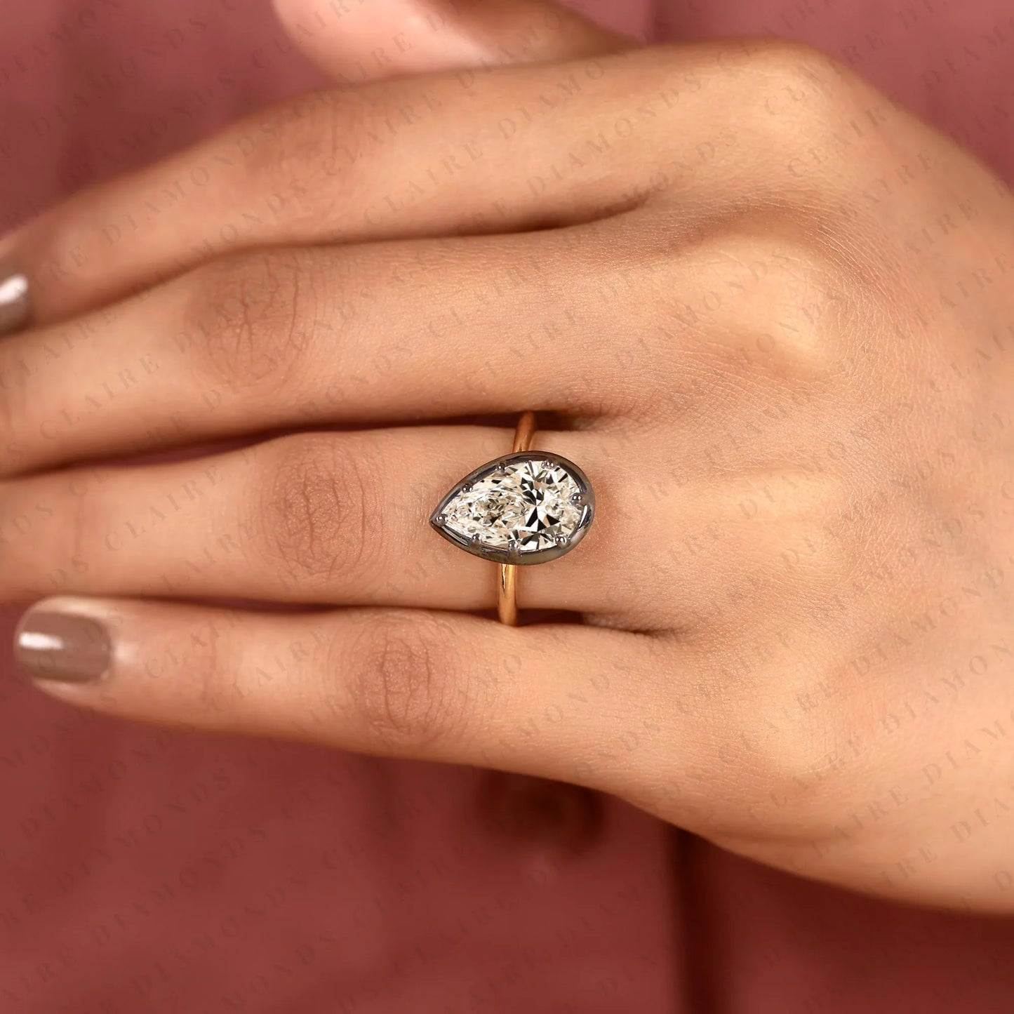 pear shape moissanite diamond solitaire ring | black bezel two-tone gold contemporary setting