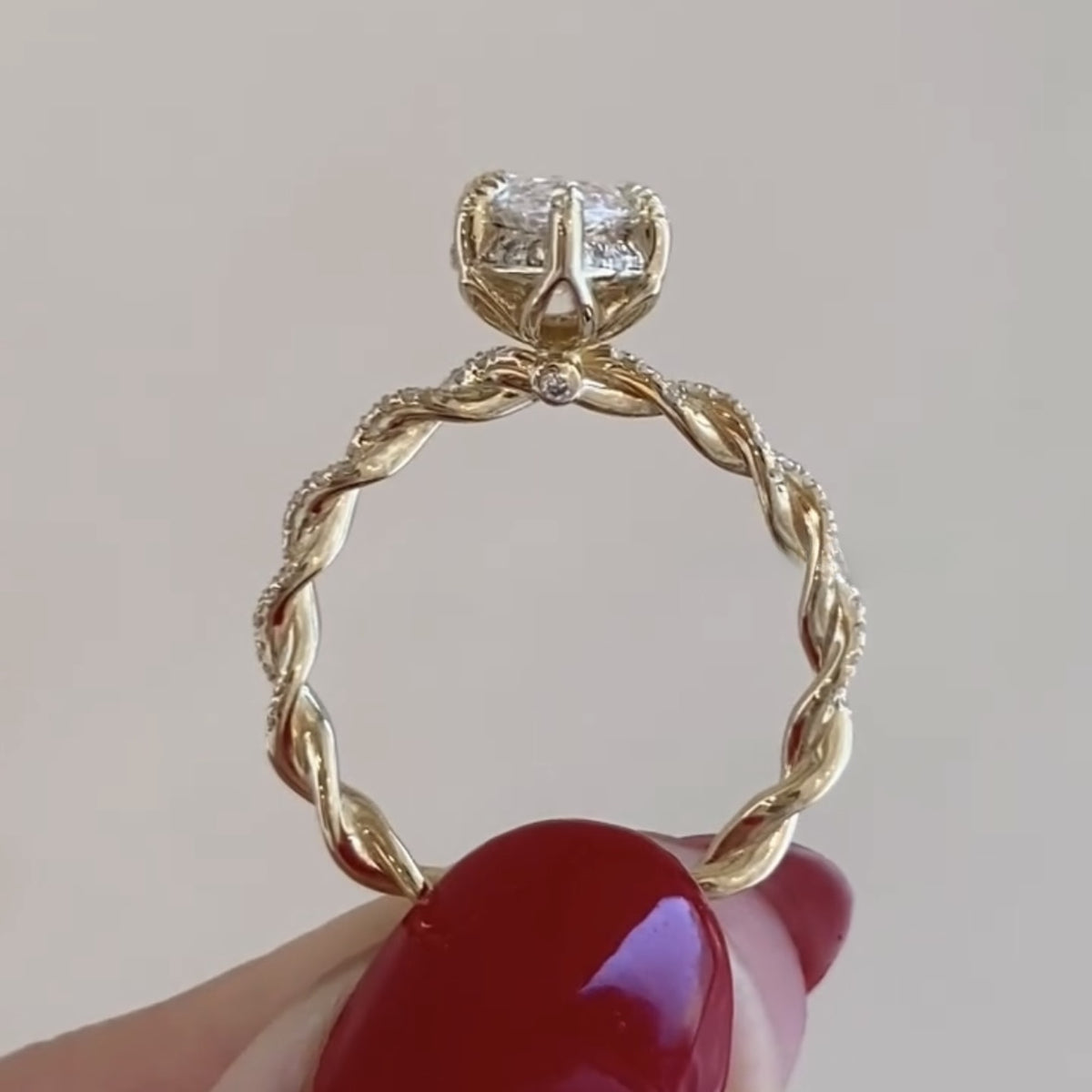 gold ring with diamond held by a hand against a neutral background, branded 'the future diamonds'.