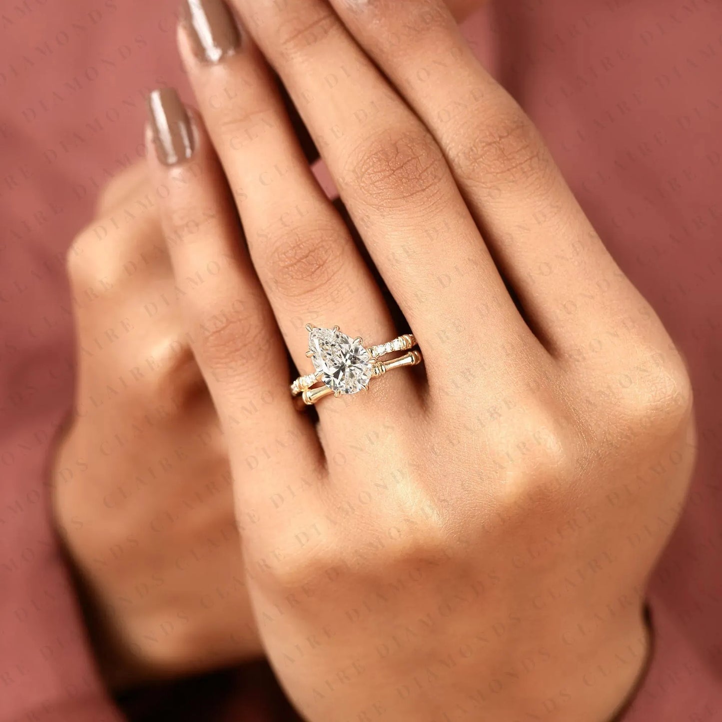 luxury pear cut moissanite diamond engagement ring with pavé diamond accents and bamboo inspired matching wedding band set