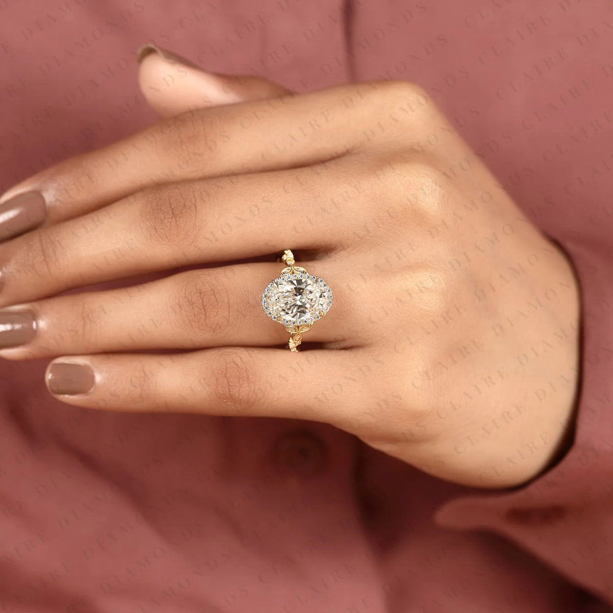 oval halo moissanite diamond engagement ring in solid gold with twisted vintage band.