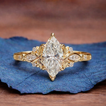Gold ring with a large diamond on a blue leaf