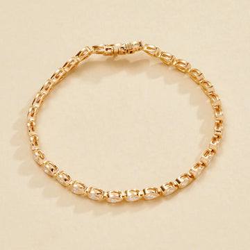 Gold bracelet on a beige