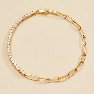 Gold bracelet with clear stones on a beige