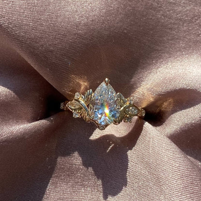 Vintage Inspired Pear Cut Moissanite Diamond Engagement Ring with Floral Leaf Side Accents in Solid Gold