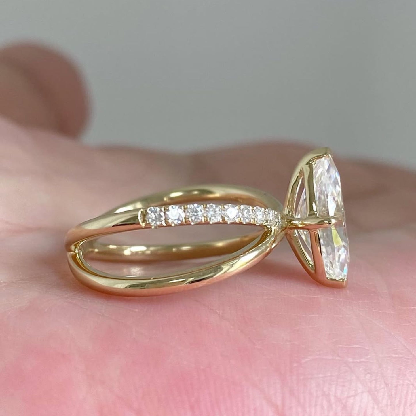 gold ring with a large diamond on a hand