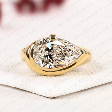 East West Pear Cut Engagement Ring Bezel Set Gold Solitaire Wedding Ring by Claire Diamonds