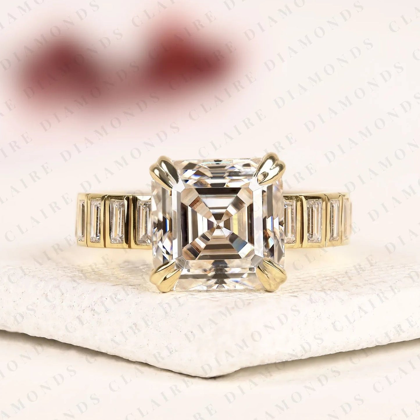 asscher cut lab diamond engagement ring with baguette accent band in gold.