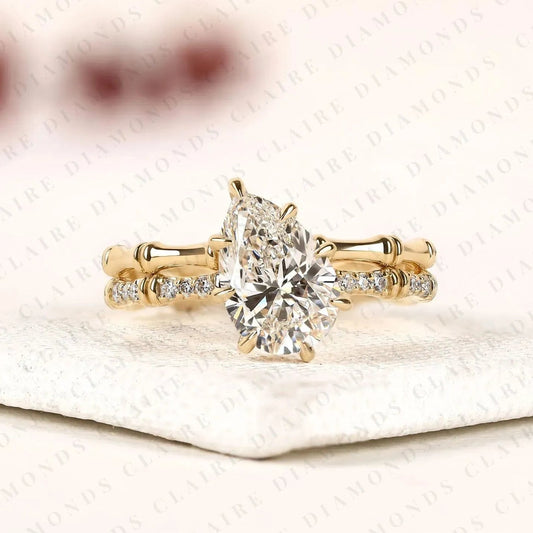 Luxury Pear Cut Moissanite Diamond Engagement Ring with Pavé Diamond Accents and Bamboo Inspired Matching Wedding Band Set