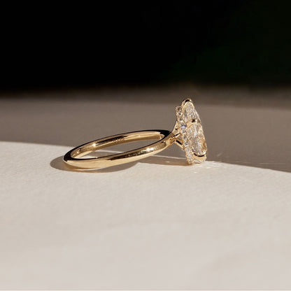 Gold ring with a diamond on a light surface