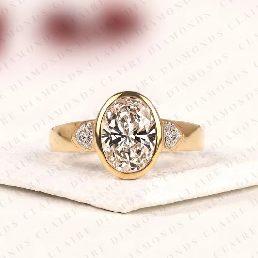 Oval Cut Lab Grown Diamond Engagement Ring | Bezel Set Gold Ring with Trillion Side Stones | Modern Luxury Bridal Ring