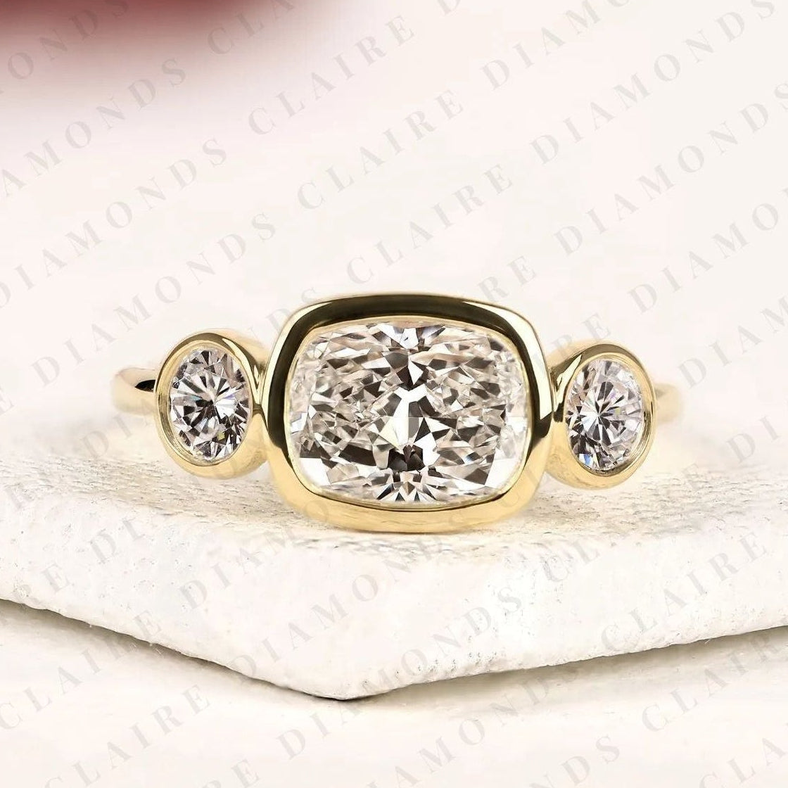 elongated cushion cut bezel set three stone moissanite diamond engagement ring modern gold ring minimalist bridal jewelry.