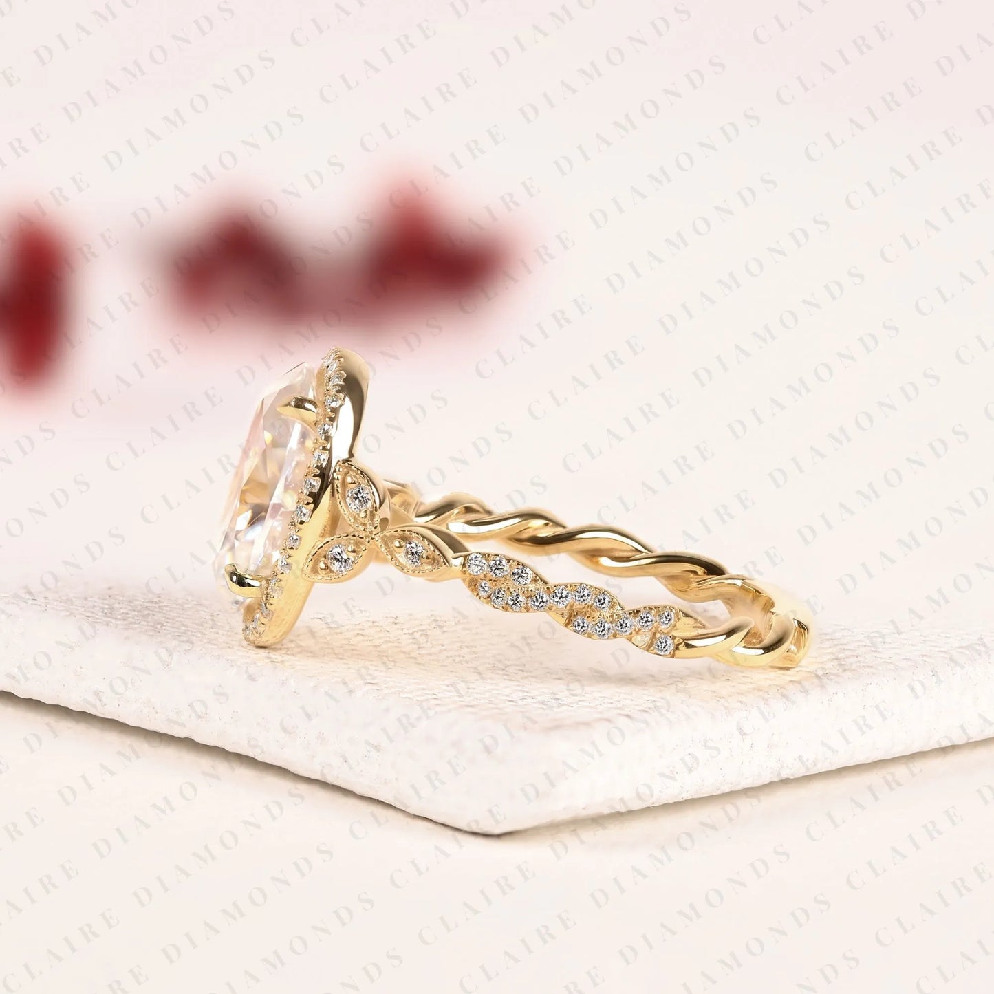 oval halo moissanite diamond engagement ring in solid gold with twisted vintage band.