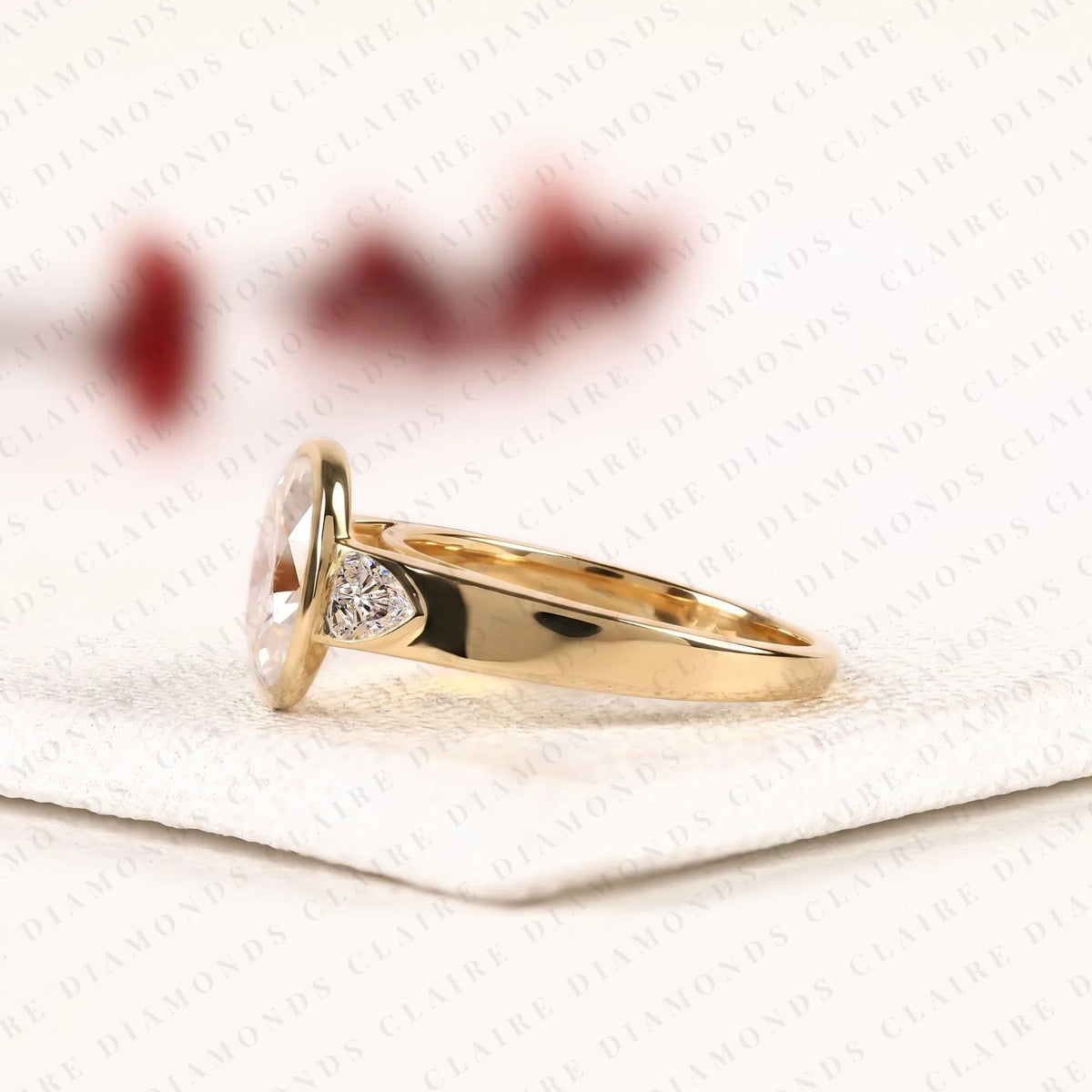 oval cut moissanite diamond engagement ring | bezel set gold ring with trillion side stones | modern luxury bridal ring