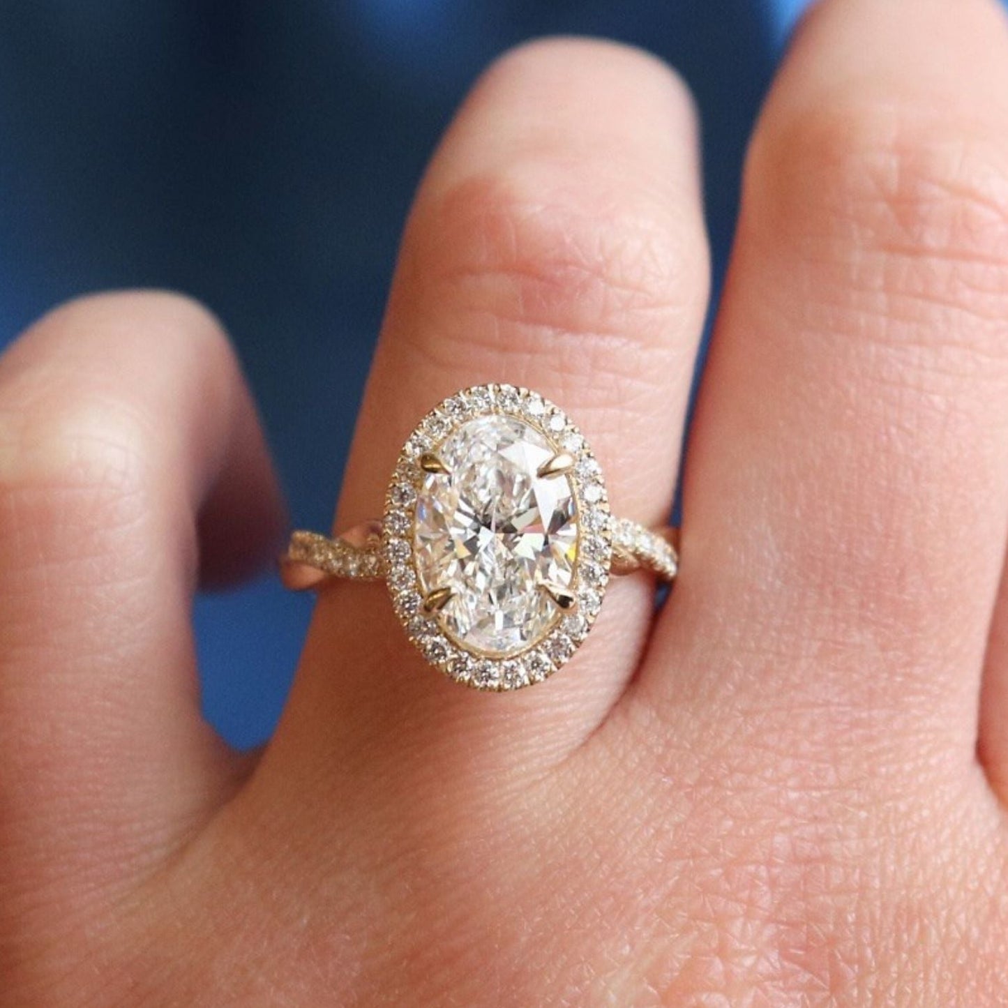 classic oval cut moissanite diamond halo ring with pave band in gold ring