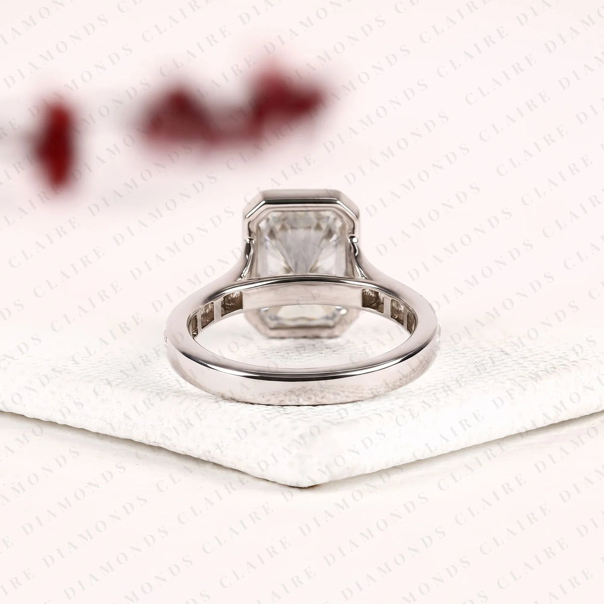 radiant cut moissanite diamond bezel set engagement ring with baguette pave set white gold modern luxury bridal jewelry
