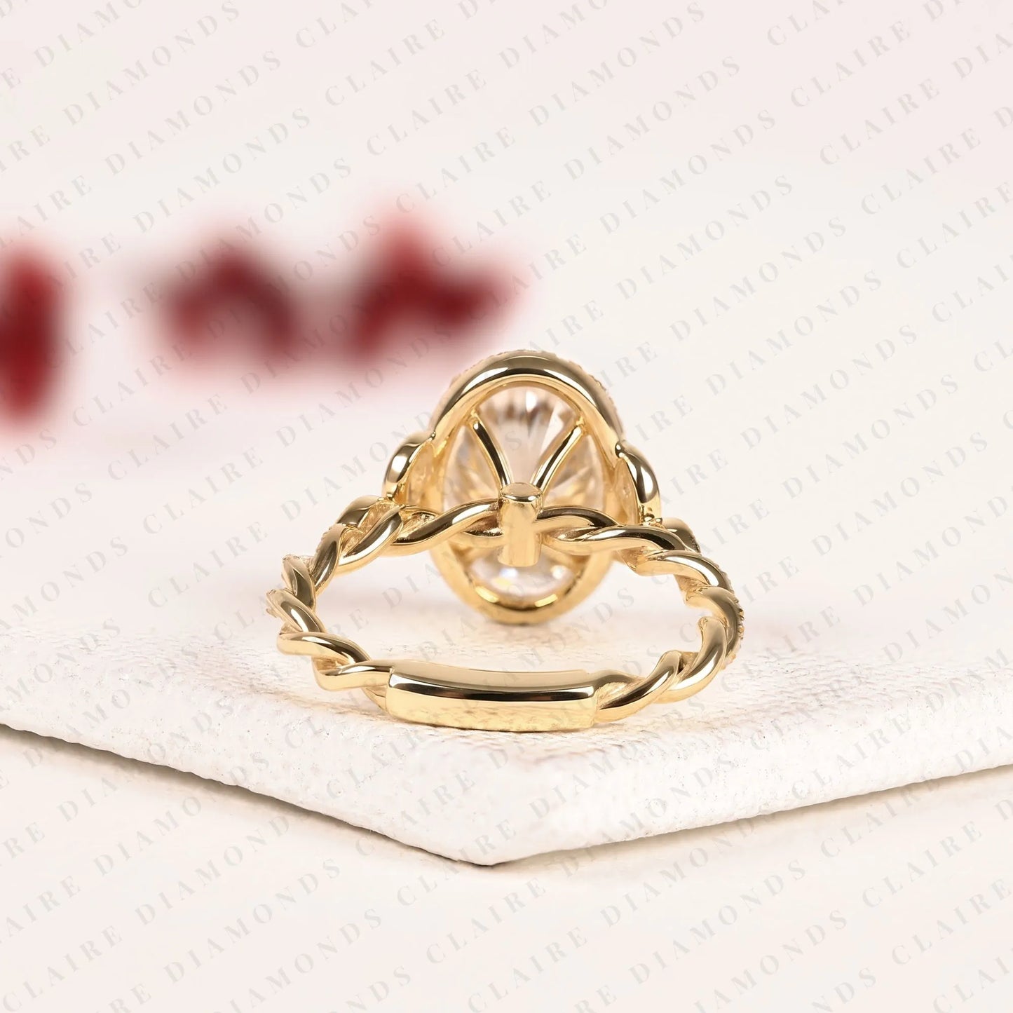 oval halo moissanite diamond engagement ring in solid gold with twisted vintage band.