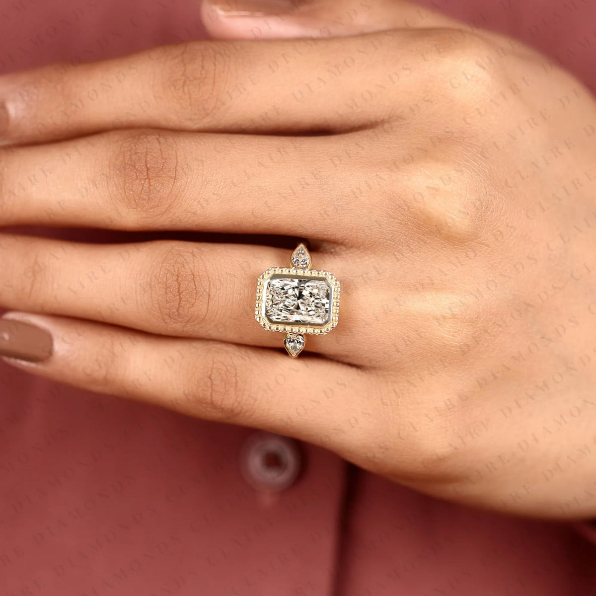 radiant cut lab grown diamond three stone engagement ring | pear cut side stone gold ring | beaded bezel statement bridal jewelry | modern luxury wedding ring