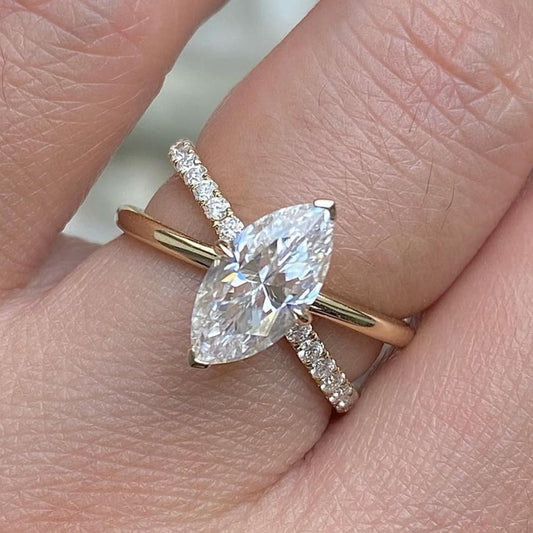 Rose gold ring with a pear-shaped diamond on a finger