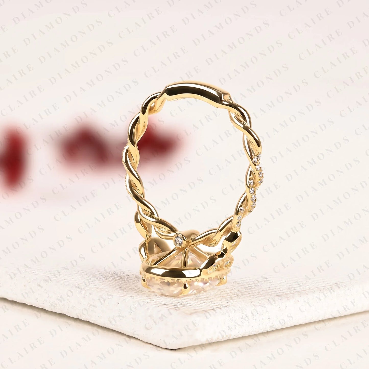 oval halo moissanite diamond engagement ring in solid gold with twisted vintage band.