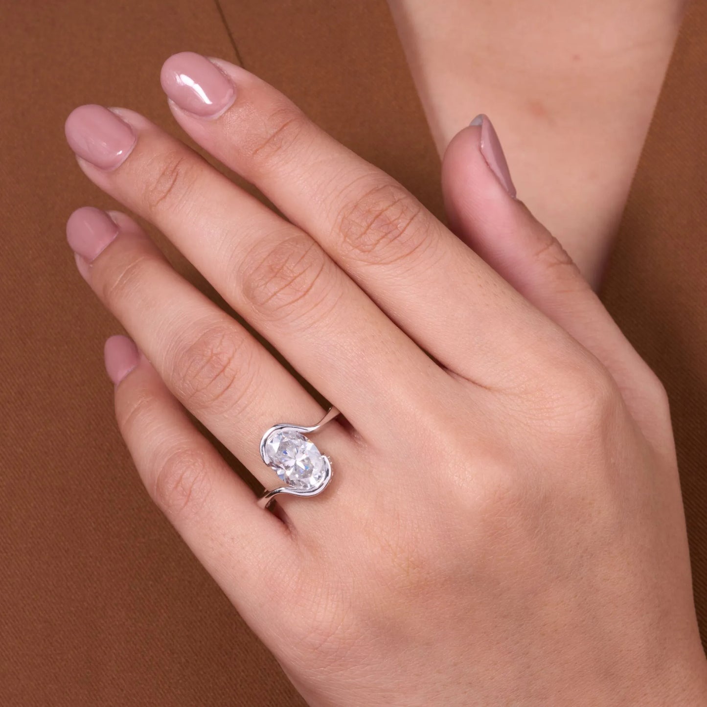 elegant oval cut moissanite diamond bypass solitaire engagement ring modern bridal design