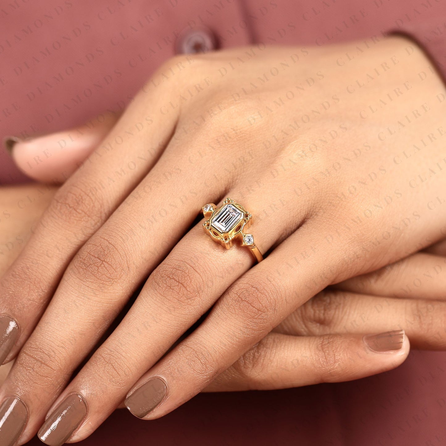emerald cut three stone bezel set lab grown diamond engagement ring | yellow gold bezel ring with round side diamonds | sculpted luxury bridal ring
