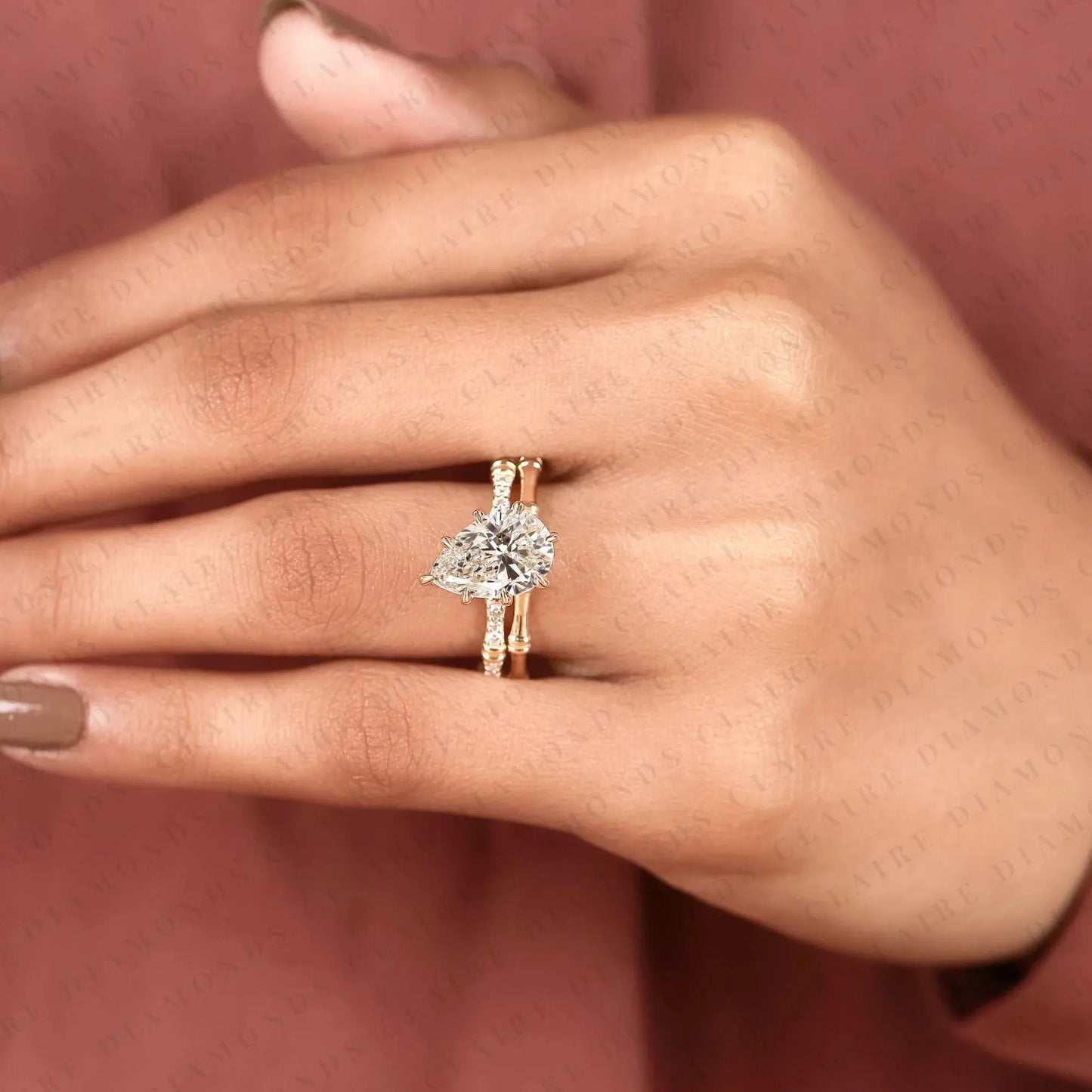 luxury pear cut moissanite diamond engagement ring with pavé diamond accents and bamboo inspired matching wedding band set