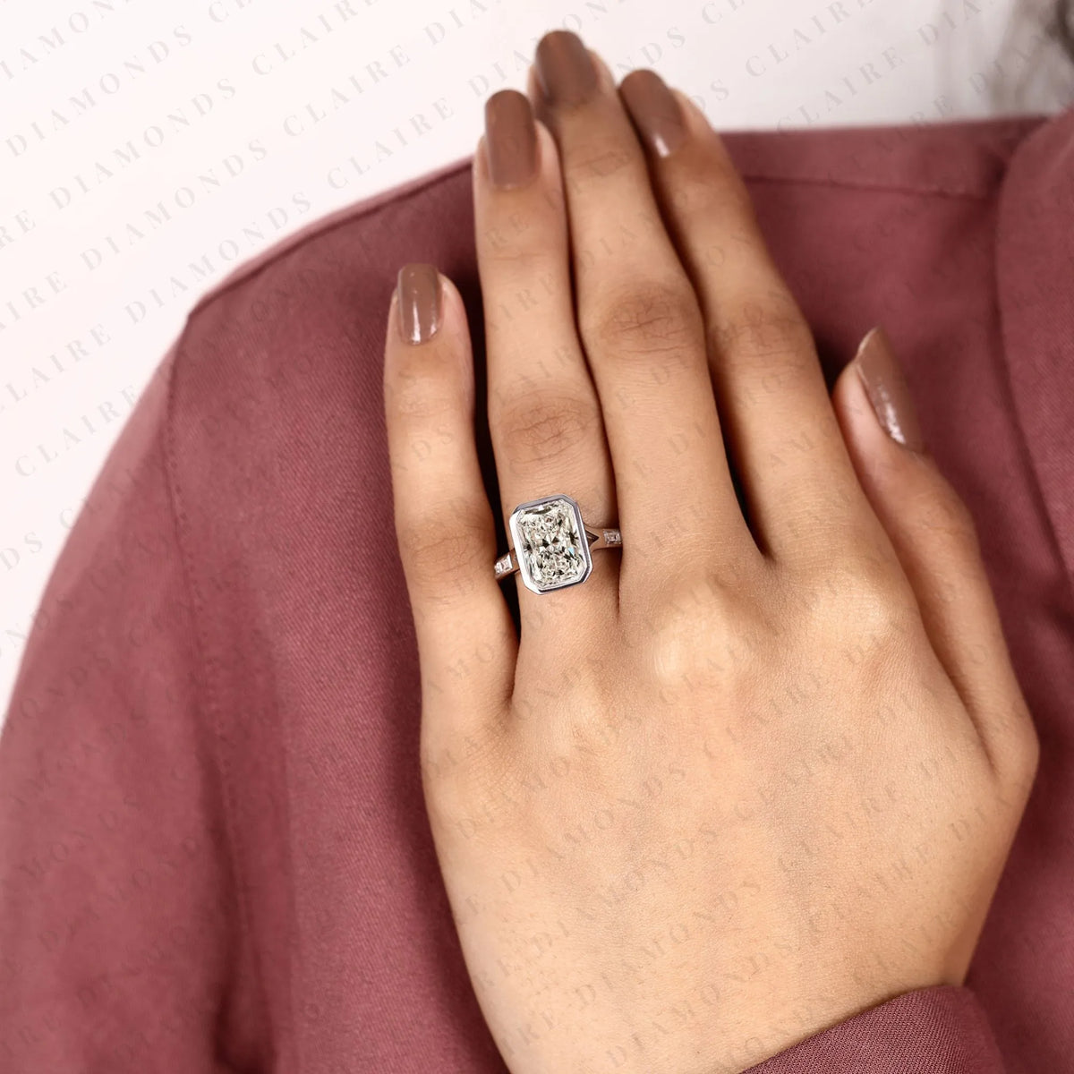 radiant cut moissanite diamond bezel set engagement ring with baguette pave set white gold modern luxury bridal jewelry