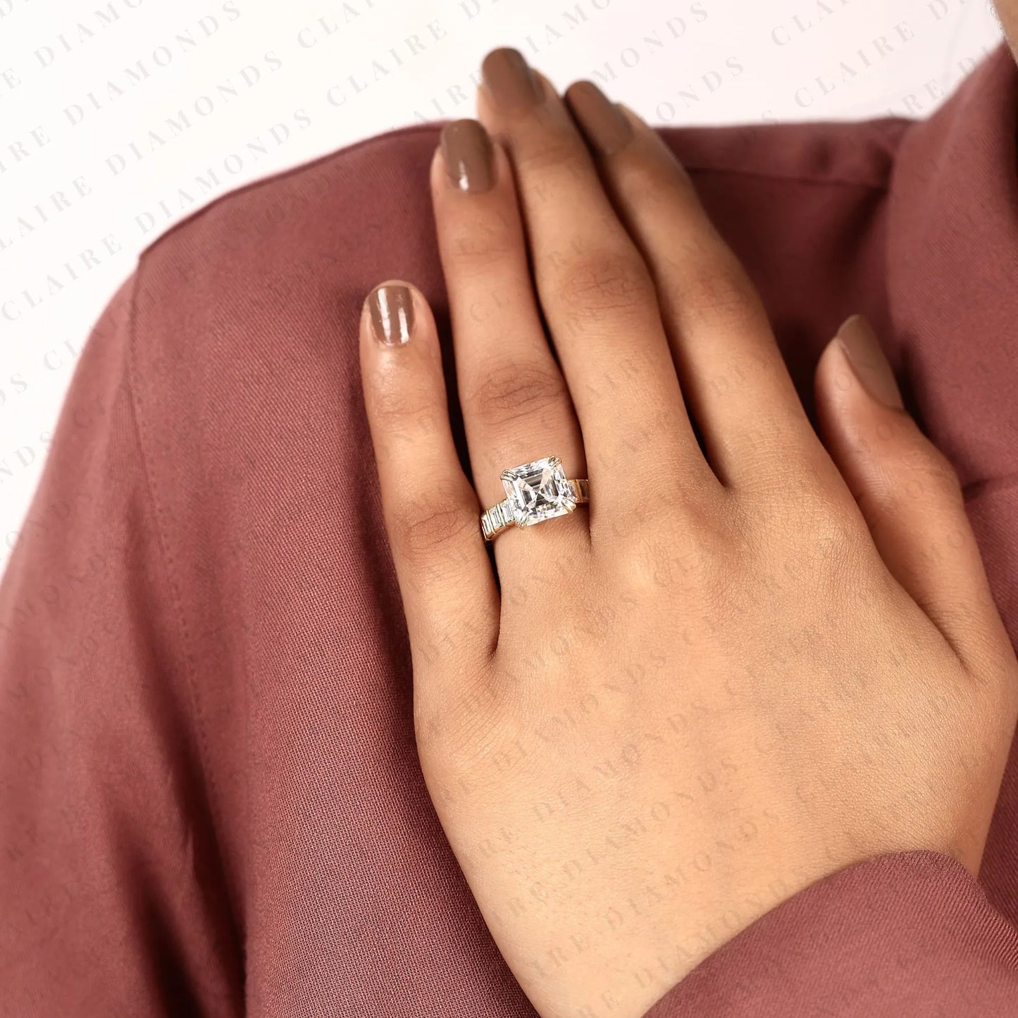 asscher cut lab diamond engagement ring with baguette accent band in gold.
