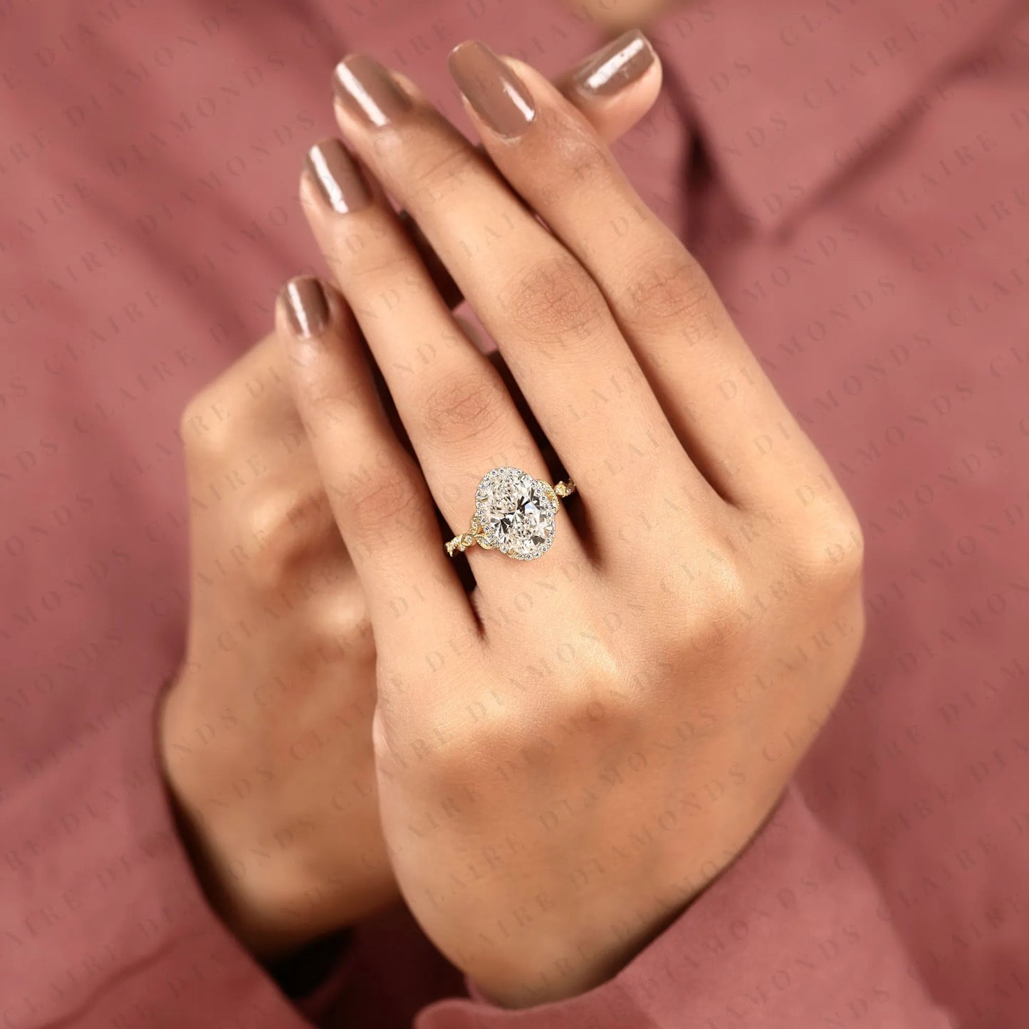 oval halo moissanite diamond engagement ring in solid gold with twisted vintage band.
