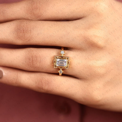 Emerald Cut Three Stone Bezel Set Lab Grown Diamond Engagement Ring | Yellow Gold Bezel Ring with Round Side Diamonds | Sculpted Luxury Bridal Ring