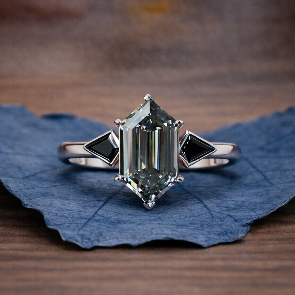 Silver ring with a large green gemstone on a blue leaf