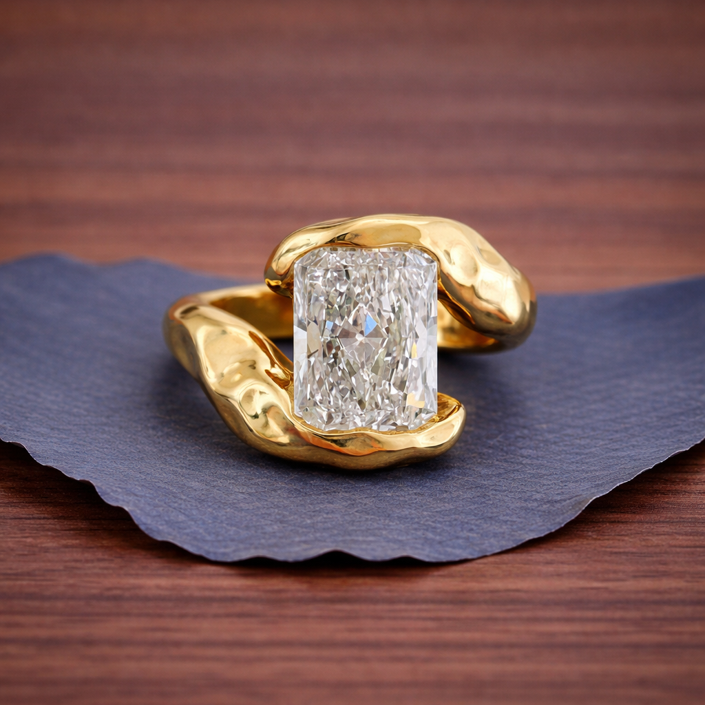 Gold ring with a large diamond on a dark blue fabric 
