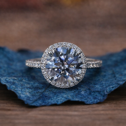 Diamond ring on a blue leaf with a blurred brown 