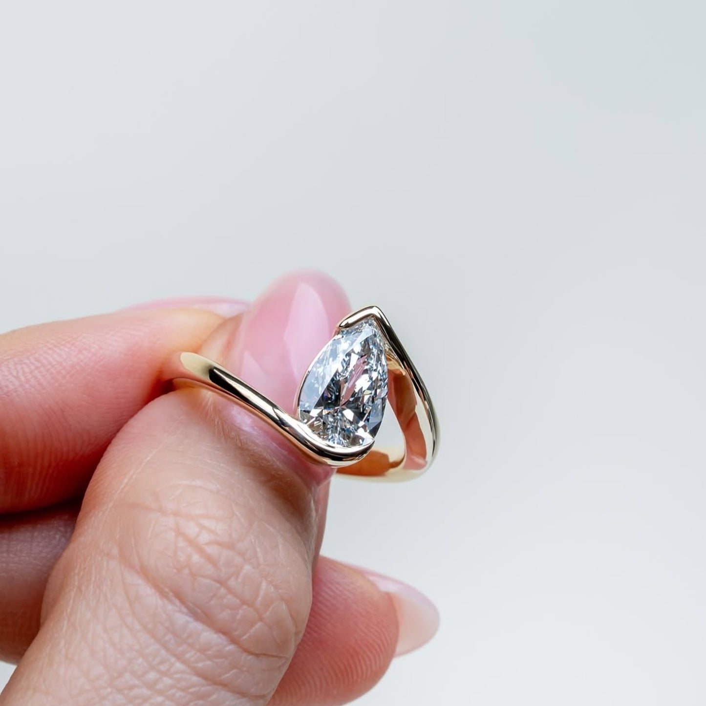 bypass pear moissanite engagement ring half bezel gold  anniversary ring