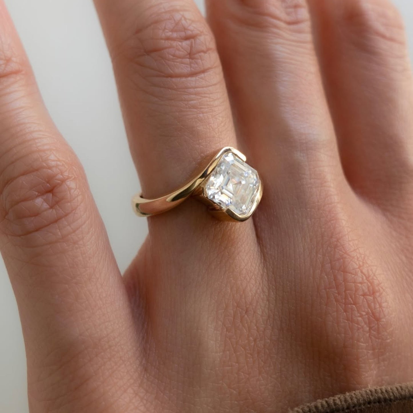 asscher cut lab grown engagement ring half bezel east west wedding ring
