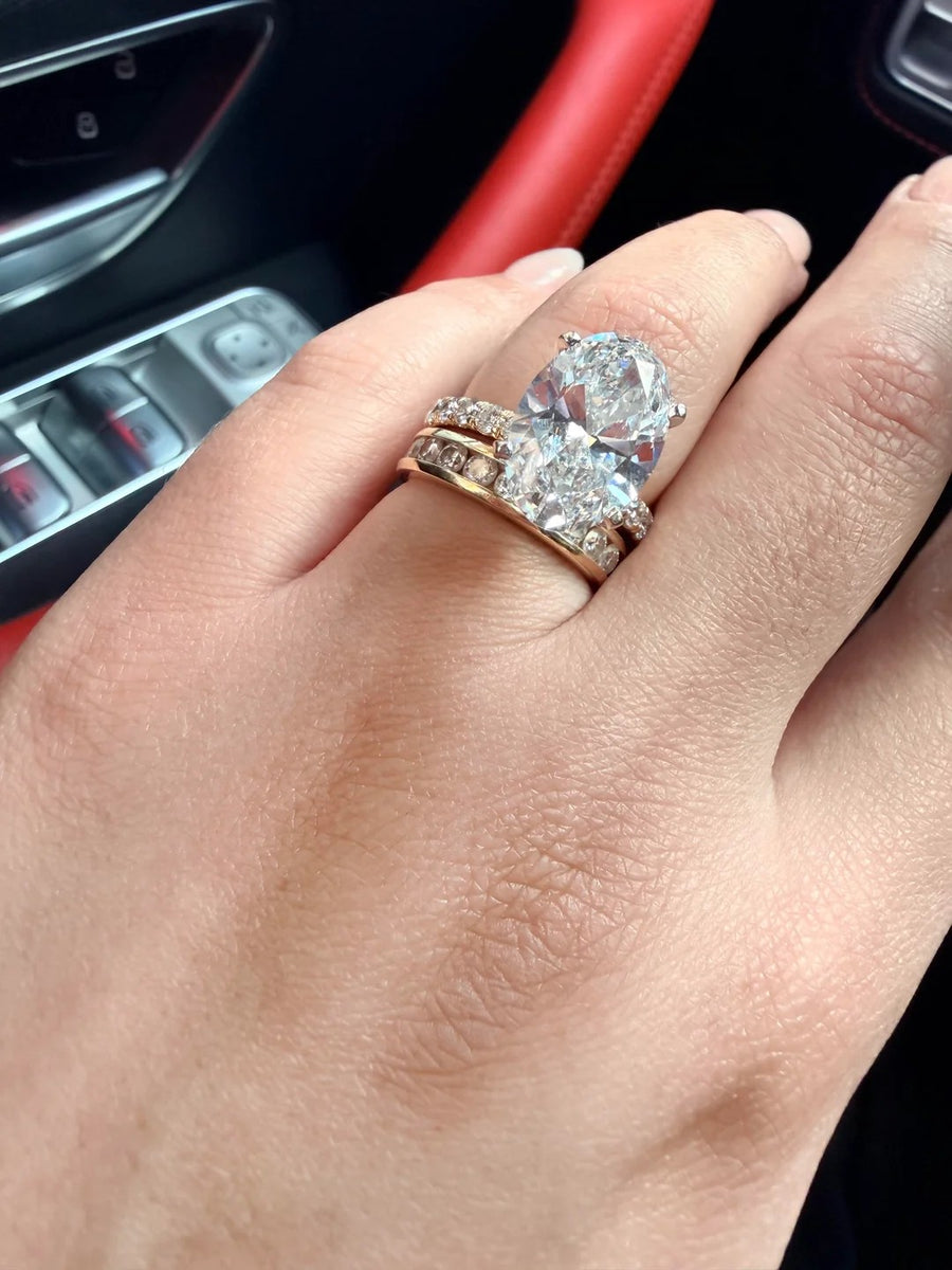 Large oval solitaire with diamond bands in rose gold