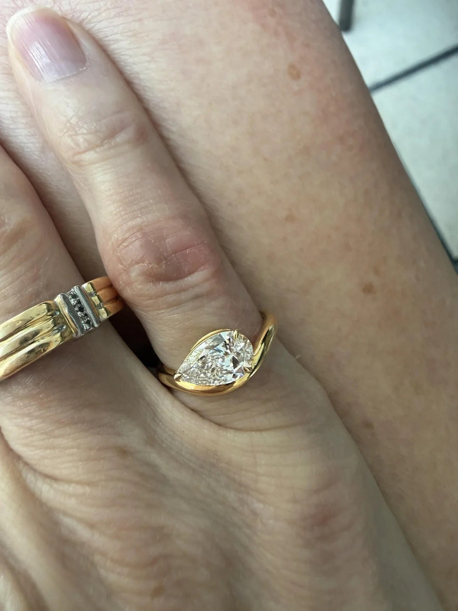 Pear solitaire in a yellow gold bypass setting