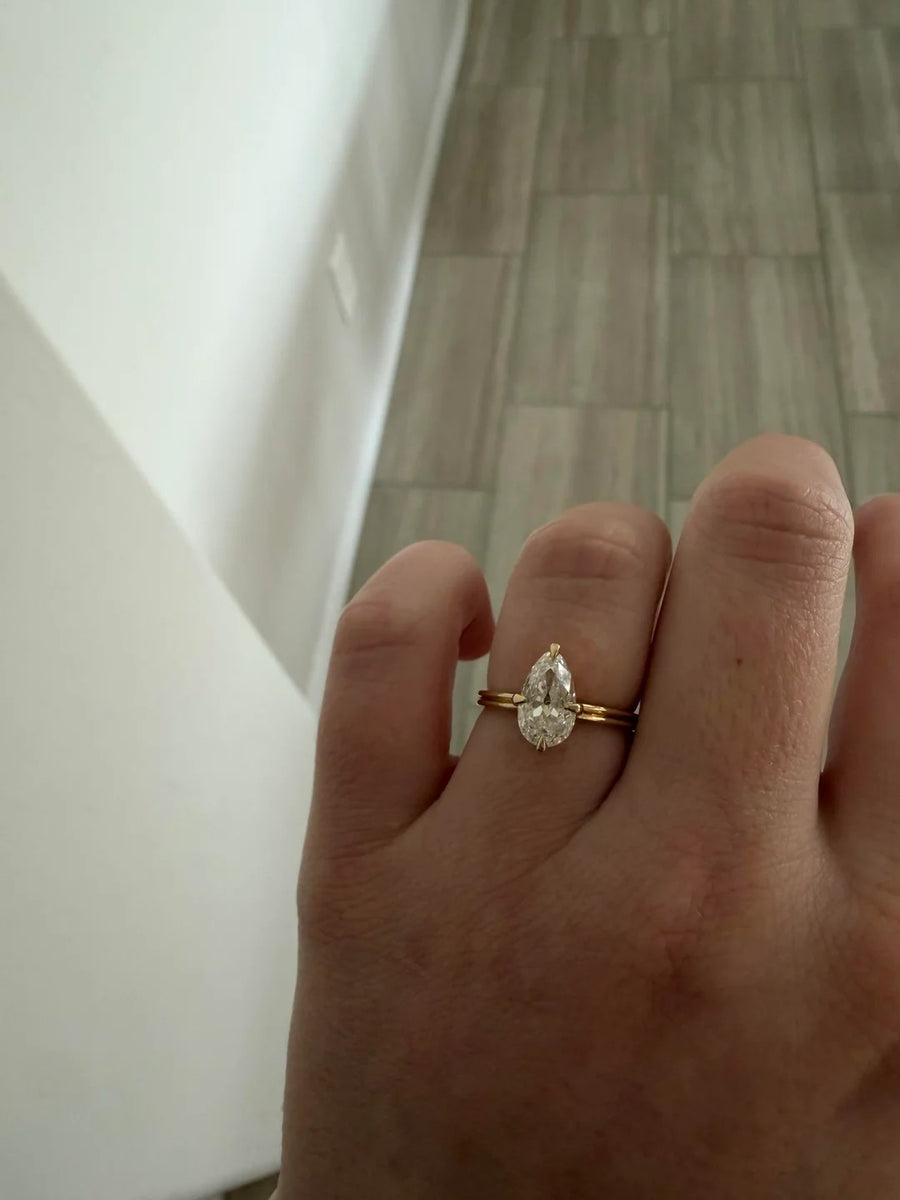 Pear solitaire ring with a thin gold band