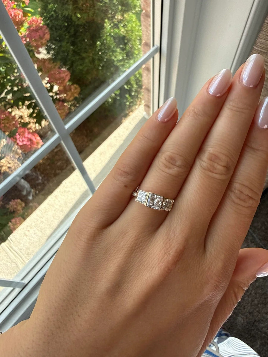 Three-stone square-cut ring in yellow gold