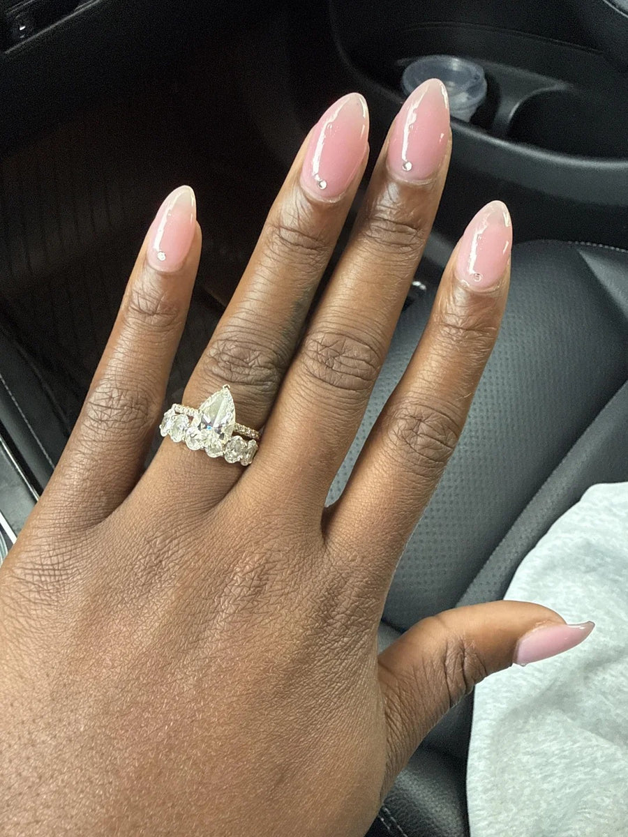 Pear diamond ring stacked with a diamond band