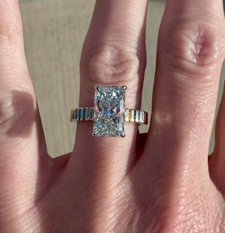 Elongated radiant cut ring on a ribbed yellow gold band