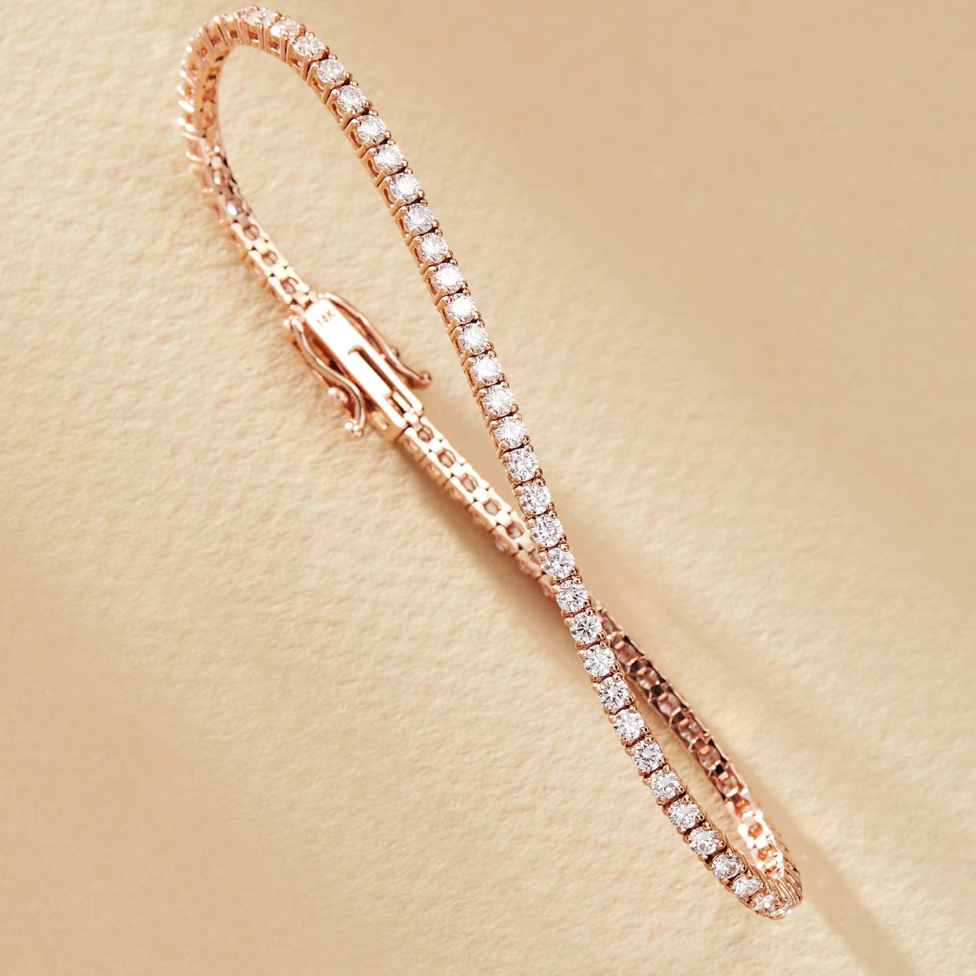 Rose gold bracelet with diamonds on a beige 