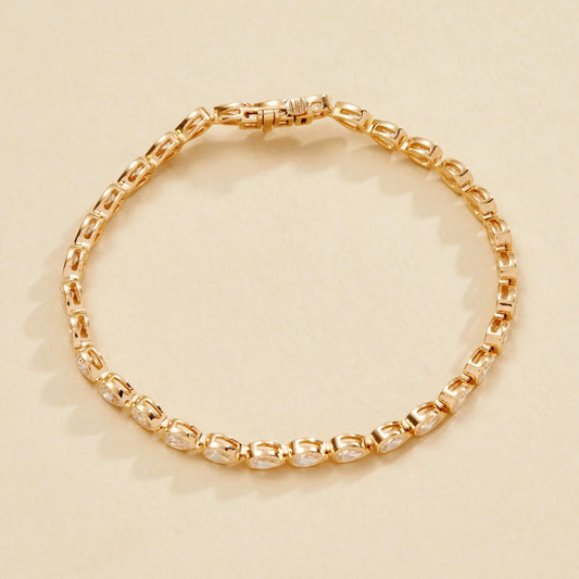 Gold bracelet on a beige 