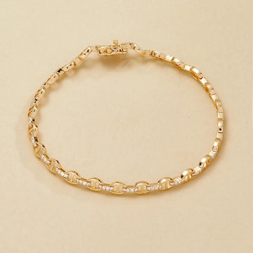 Gold bracelet on a beige 