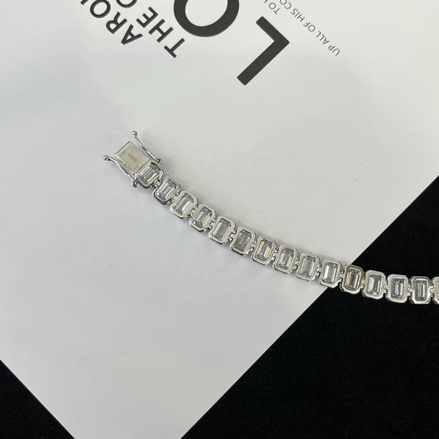 silver bracelet on a black and white checkered 