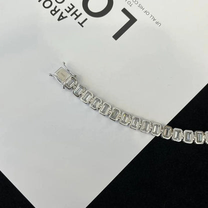 Silver bracelet on a black and white checkered 